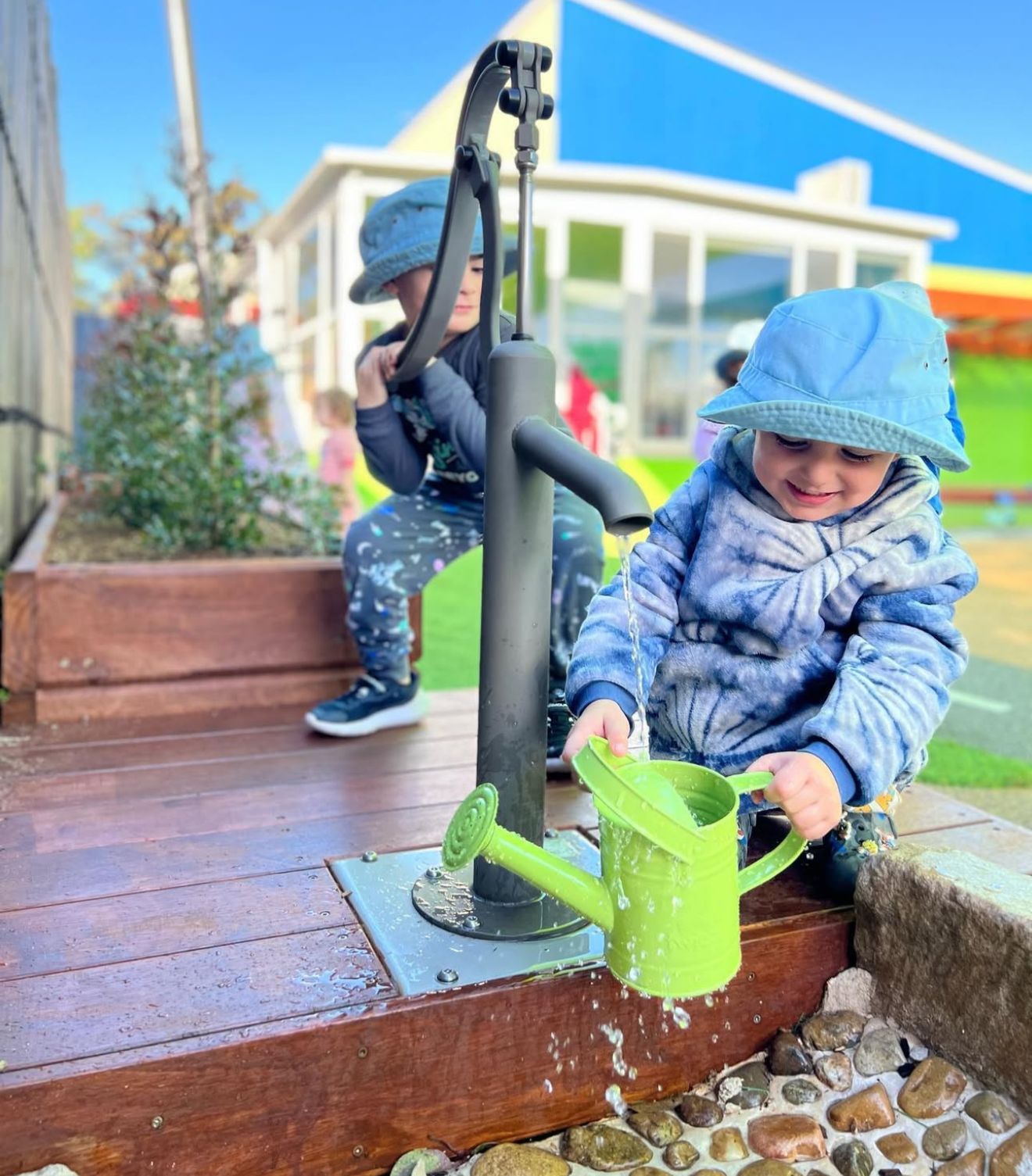 Curious child playing with ourtdoor water tap